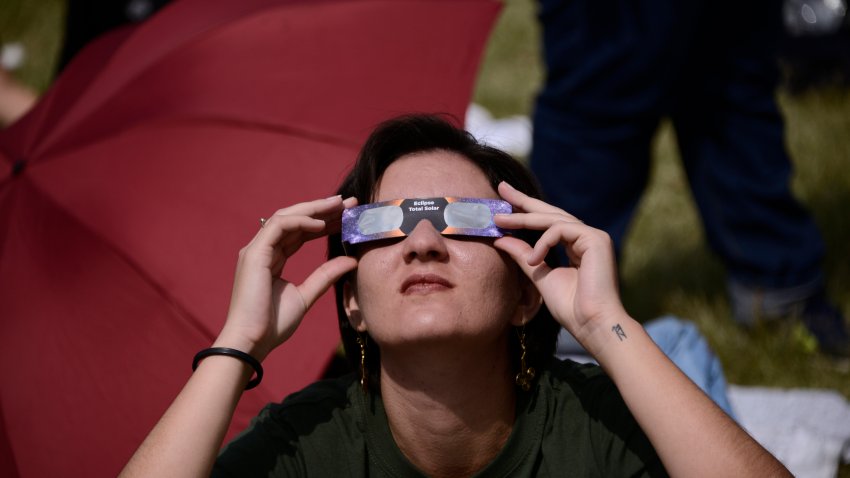 October 14, 2023, Mexico City, Mexico: A  woman is seen watching the Annular Solar Eclipse with special sun filter  glasses at the National Autonomous University of Mexico (UNAM). (Photo by Carlos Tischler/ Eyepix Group) (Photo credit should read Carlos Tischler/ Eyepix Group/Future Publishing via Getty Images)