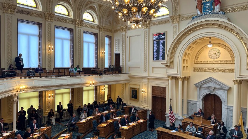 Assembly Speaker Craig Coughlin, in the central chair on the dais, moderates debate over legislation overhauling the state’s open records in Trenton, N.J., Monday, May 13, 2024. Over jeers of “shame” shouted from the gallery, state lawmakers passed legislation to overhaul the state’s open public records law despite objections from civil rights groups and the state’s press association. The Associated Press signed onto a letter by the state’s press association urging the bill to be rejected. (AP Photo/Mike Catalini)