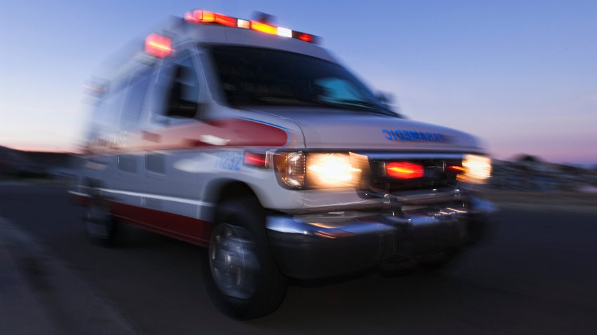 Blurred view of ambulance driving at dusk