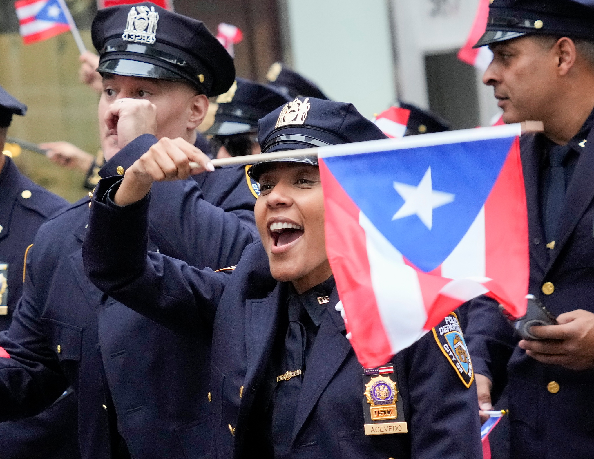 New York (United States), 09/06/2024.- A New York City police officer waves a Puerto Rican flag during the 67th National Puerto Rican Day Parade in New York, New York, USA, 09 June 2024. The annual event is one of the USA’s largest celebrations of Puerto Rican culture, arts, and achievement. (Nueva York) EFE/EPA/PORTER BINKS