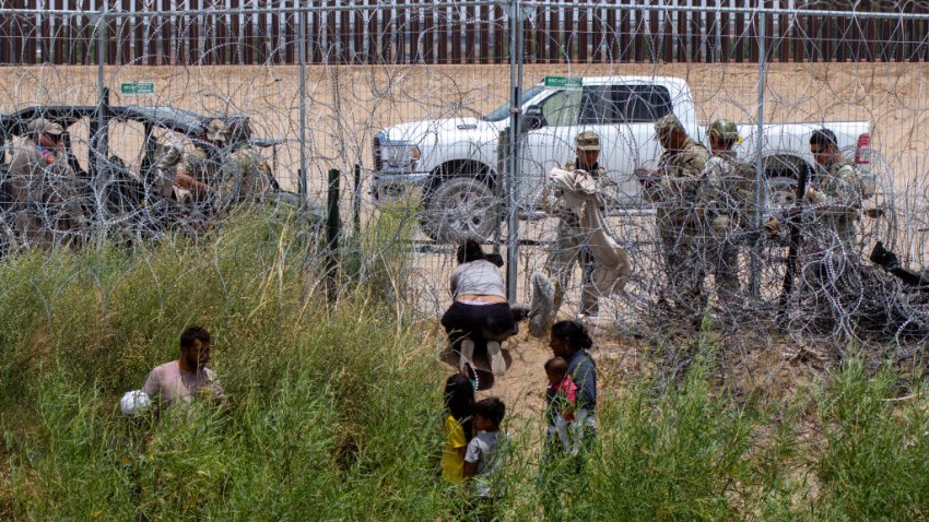 CIUDAD JUAREZ, MEXICO – JUNE 4: Some migrants await the opportunity to cross the border while Texas National Guard and state police prevent crossings on Ciudad Juarez, Mexico on June 4, 2024. President Biden signed an agreement today that includes closing asylum applications if there are more than 5,000 migrant crossings per day. Under a proclamation and an interim rule from the Departments of Justice and Homeland Security, immigrants who illegally cross the border will be prohibited from receiving asylum. These measures aim to quickly expel those without a legal basis to remain in the U.S. (Photo by David Peinado/Anadolu via Getty Images)