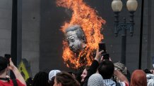 WASHINGTON, DC - JULY 24: Protestors burn a photo of Benjamin Netanyahu outside of Union Station on July 24, 2024 in Washington, DC.  The demonstrators gathered to protest Israeli Prime Minister Benjamin Netanyahu's visit to the United States amid Israel's ongoing war against Hamas in Gaza. (Photo by Michael A. McCoy/Getty Images)