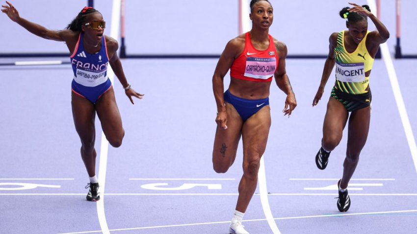 Puerto Rico’s Jasmine Camacho-Quinn, France’s Cyrena Samba-Mayela and Jamaica’s Ackera Nugent cross the finish line in the women’s 100m hurdles semi-final of the athletics event at the Paris 2024 Olympic Games at Stade de France in Saint-Denis, north of Paris, on August 9, 2024. (Photo by Anne-Christine POUJOULAT / AFP) (Photo by ANNE-CHRISTINE POUJOULAT/AFP via Getty Images)