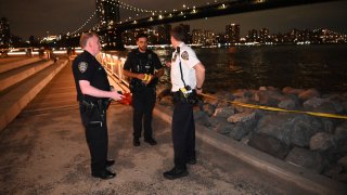 Medical examiners and the NYPD are investigating at the crime scene after bone fragments recovered along the shoreline at the Brooklyn Bridge Park in Brooklyn, New York, United States on August 31, 2024. At approximately 7:00 p.m. Saturday evening near Jane's Carousel at Brooklyn Bridge Park by Dock Street, bone fragments were recovered along the rocks along the shoreline. (Photo by Kyle Mazza/Anadolu via Getty Images)