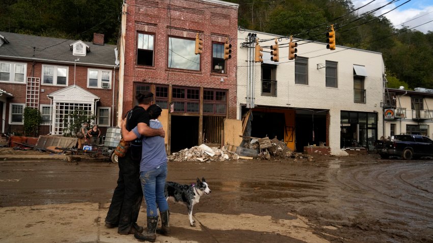 FILE – Resident Anne Schneider, right, hugs her friend Eddy Sampson as they survey damage left in the wake of Hurricane Helene, Oct. 1, 2024, in Marshall, N.C. (AP Photo/Jeff Roberson, File)