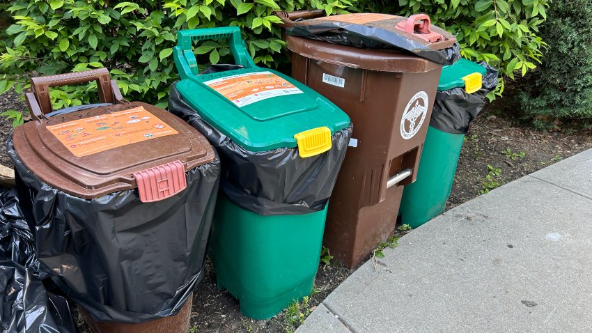 Several city Compost, food scrap collection bins lined up on sidewalk, Queens, New York. (Photo by: Lindsey Nicholson/UCG/Universal Images Group via Getty Images)