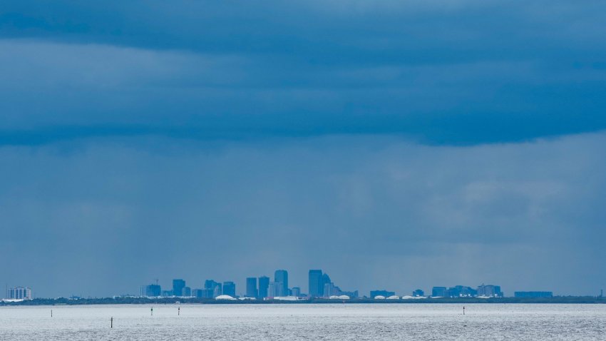 A thunderstorm can be seen moving over Tampa in the distance from St. Petersburg, Florida ahead of Hurricane Milton’s expected landfall in the middle of this week on October 8, 2024. Storm-battered Florida girded Tuesday for a direct hit from Hurricane Milton, a monster weather system threatening catastrophic damage and forcing President Joe Biden to postpone a major overseas trip. (Photo by Bryan R. SMITH / AFP) (Photo by BRYAN R. SMITH/AFP via Getty Images)