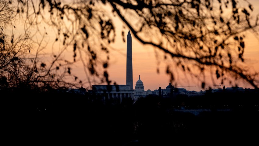 The Lincoln Memorial, Washington Monument, and US Capitol at sunrise in Washington, DC, on January 16, 2022, ahead of a winter storm. – A winter storm is hitting the US Southeast January 16, with freezing rain, ice and snow. Winter weather alerts extend across the US East Coast, stretching over 1,400 miles and affecting some 80 million people, accroding to media reports. (Photo by Stefani Reynolds / AFP) (Photo by STEFANI REYNOLDS/AFP via Getty Images)