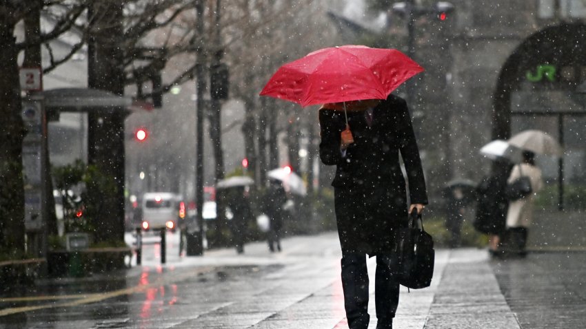 TOKYO, JAPAN – FEBRUARY 5: People walk on the street in Tokyo, Japan on February 5, 2024, as first snowflakes are seen in the capital of Japan. (Photo by David Mareuil/Anadolu via Getty Images)