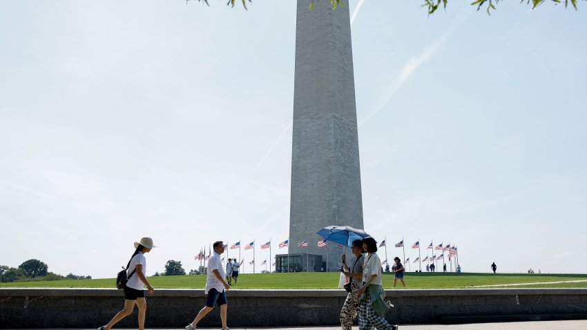 WASHINGTON, DC – AUGUST 28: People walk near the Washington Monument on the National Mall on August 28, 2024 in Washington, DC. Cities along the East Coast including Washington DC are experiencing a late summer heat wave where temperatures are reaching near 100 degrees Fahrenheit. (Photo by Anna Moneymaker/Getty Images)