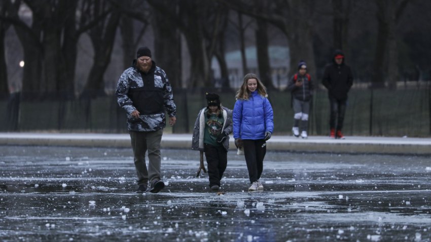 WASHINGTON D.C., USA – DECEMBER 26: People walk over the frozen pool by the Lincoln Memorial in Washington D.C., United States on December 26, 2022. (Photo by Celal Gunes/Anadolu Agency via Getty Images)