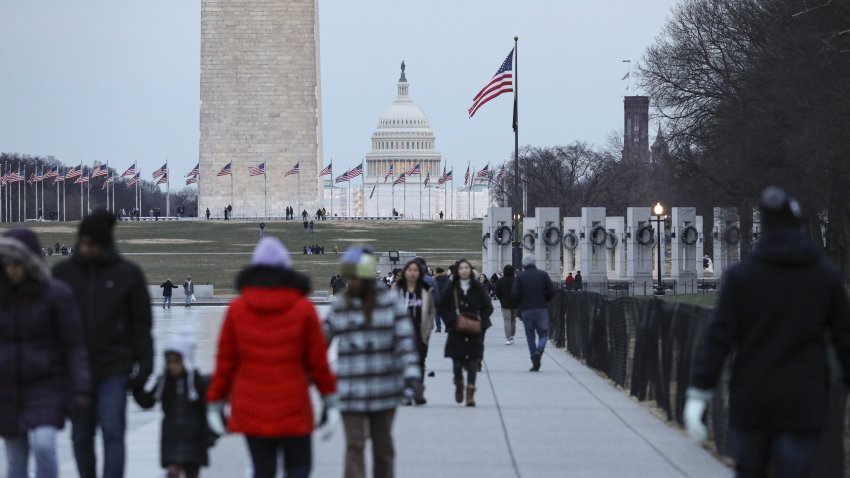 WASHINGTON D.C., USA – DECEMBER 26: People walk over the frozen pool by the Lincoln Memorial in Washington D.C., United States on December 26, 2022. (Photo by Celal Gunes/Anadolu Agency via Getty Images)