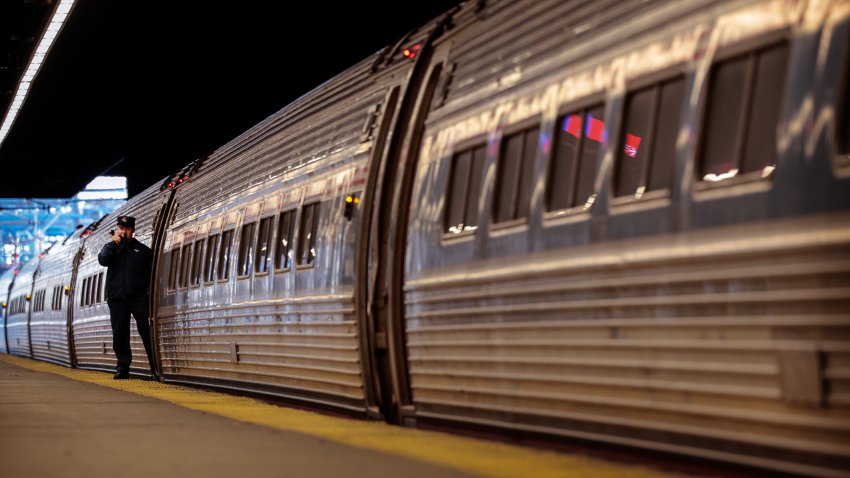 Boston, MA – November 27: An Amtrak Conductor prepares a train for departure at South Station. (Photo by Craig F. Walker/The Boston Globe via Getty Images)