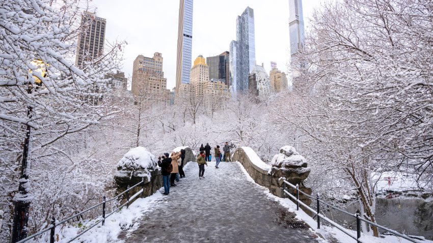 NEW YORK, NEW YORK – DECEMBER 21: People walk over the Gapstow Bridge as snow falls in Central Park on December 21, 2024 in New York City. (Photo by Craig T Fruchtman/Getty Images)