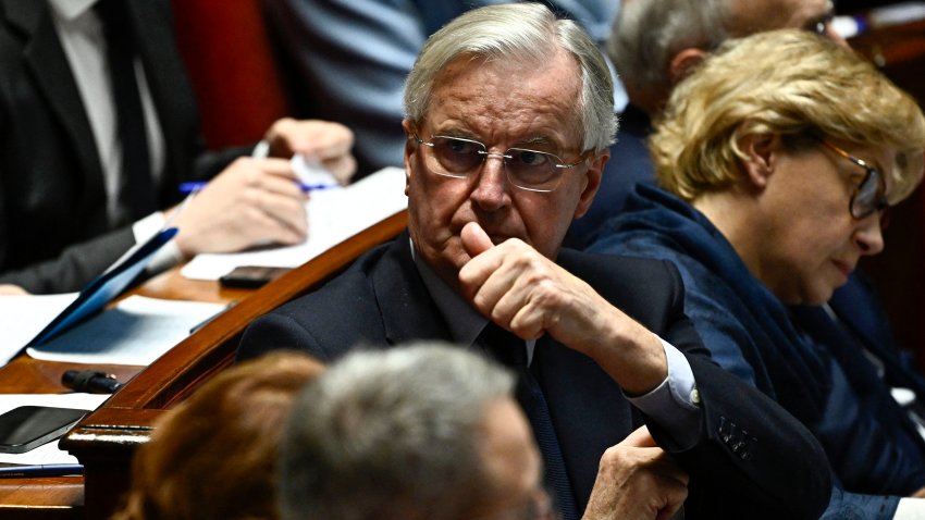 France’s Prime Minister Michel Barnier (C) looks on during a session of questions to the government at The National Assembly in Paris, on December 3, 2024. On December 3, 2024, the Conference of Presidents of the National Assembly is expected to decide on the date for the debate and vote on a motion of no confidence, which has every chance of being approved, as the Nouveau Front Populaire (NFP) and the Rassemblement National (RN) have announced that they will vote in its favour. (Photo by JULIEN DE ROSA / AFP) (Photo by JULIEN DE ROSA/AFP via Getty Images)