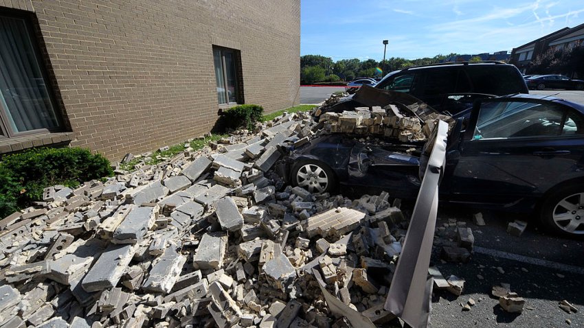 VIENNA, VA – AUGUST 23, 2011. A witness says when the earthquake hit, bricks fell off the 8304 Old Georgetown Rd building in Vienna, VA and smashed these four vehicles on August 23, 2011.  (Photo by Tracy A Woodward/The Washington Post via Getty Images)