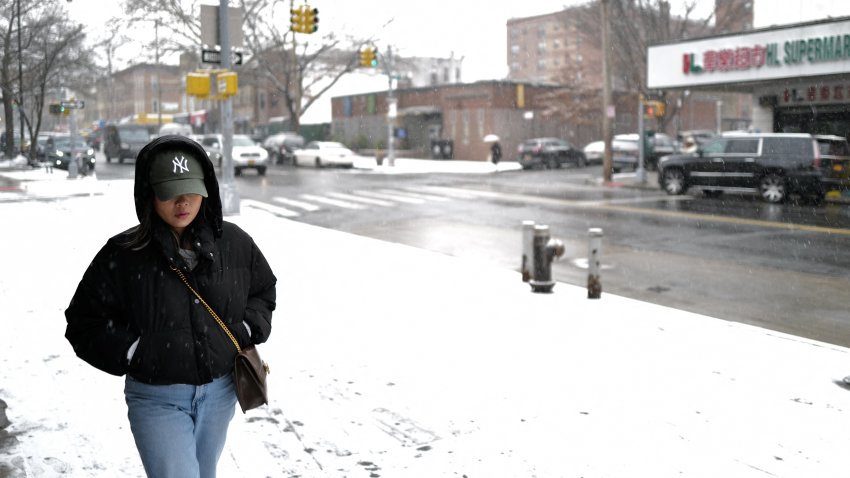 A person walks down the street as snow falls in the Brooklyn borough of New York City on January 6, 2025. A massive storm system dumped heavy snow and freezing rain on large swaths of the eastern United States Monday, disrupting travel and work for millions of Americans from the Ohio Valley to the capital Washington. (Photo by CHARLY TRIBALLEAU / AFP) (Photo by CHARLY TRIBALLEAU/AFP via Getty Images)