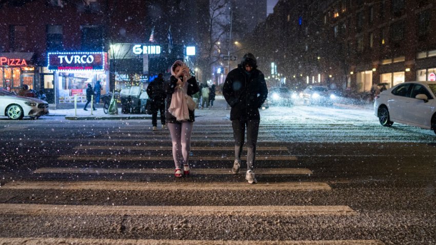 NEW YORK, NEW YORK – JANUARY 19: People walk along Ninth Avenue in the snow in Hell’s Kitchen at night on January 19, 2025 in New York City. (Photo by Craig T Fruchtman/Getty Images)