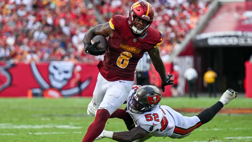 TAMPA, FL – SEPTEMBER 8: Washington Commanders running back Brian Robinson Jr. (8) evades a tackle in a game between the Washington Commanders and the Tampa Bay Buccaneers at Raymond James Stadium in Tampa, Fla. on September 8, 2024. (Photo by Thomas Simonetti for The Washington Post via Getty Images)