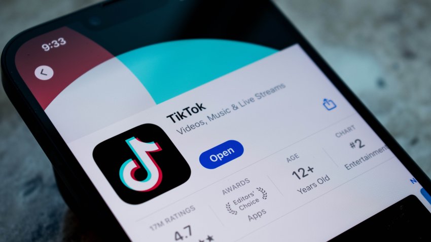 SALT LAKE CITY, UTAH, USA – JULY 12, 2024: Man holds smart phone with TikTok application on the screen. TikTok is a video-sharing app for smartphones.