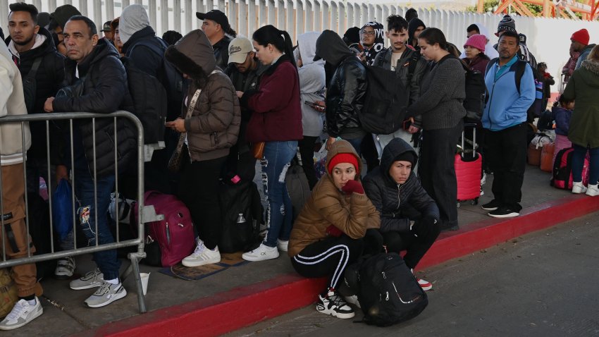 Asylum seekers wait for their CBP One appointments before crossing through El Chaparral border port in Tijuana, Mexico, on January 20, 2025. The Trump administration shuts down the CBP One app for migrants. The Biden-era process allows nearly 1 million migrants to enter the US at legal border crossings since the app initiates. It is estimated that 270,000 migrants wait in Mexico, hoping to use the app to enter the US. (Photo by Carlos Moreno/NurPhoto via Getty Images)