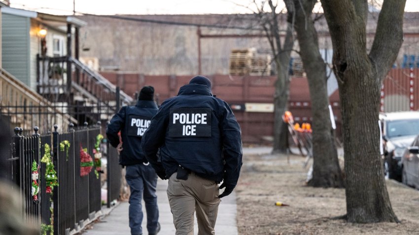 US Immigration and Customs Enforcement (ICE) agents walk down a street during a multi-agency targeted enforcement operation in Chicago, Illinois, US, on Sunday, Jan. 26, 2025. President Donald Trump has pledged to carry out the largest deportation effort in US history, vowing to ultimately deport all of the foreigners living in the country without permission. Photographer: Christopher Dilts/Bloomberg via Getty Images