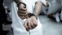 TECOLUCA, EL SALVADOR – MARCH 16: In this handout photo provided by the Salvadoran government, a close view of handcuffs placed on the hands of a newly admitted inmate allegedly linked to criminal organizations at CECOT on March 16, 2025 in Tecoluca, El Salvador. Trump’s administration deported 238 alleged members of the Venezuelan criminal organizations ‘Tren De Aragua’ and Mara Salvatrucha with only 23 being members of the Mara. Nayib Bukele president of El Salvador announced that his government will receive the alleged members of the gang to be taken to CECOT. On February of 2023 El Salvador inaugurated Latin America’s largest prison as part of President Nayib Bukele’s plan to fight gangs. (Photo by Salvadoran Government via Getty Images)