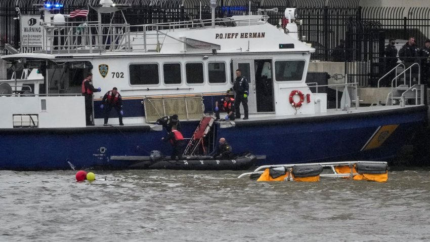 Rescue workers and emergency personnel work at the scene of a helicopter crash on the Hudson River near lower Manhattan in New York, U.S., April 10, 2025. 
