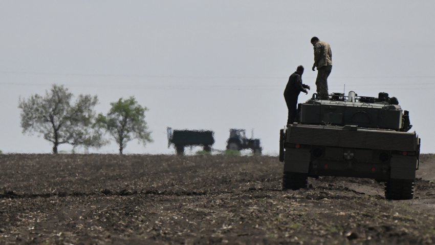 Members of a tank crew of the Ukrainian 33rd Separate Mechanized Brigade stand on a Leopard 2A4 tank as they take part in a field training exercise at an undisclosed location in Ukraine, on April 30, 2025, amid the Russian invasion of Ukraine. (Photo by Genya SAVILOV / AFP) (Photo by GENYA SAVILOV/AFP via Getty Images)