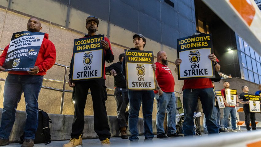 Union members from the Brotherhood of Locomotive Engineers and Trainmen form a picket line outside the NJ Transit Headquarters on Friday, May 16, 2025 in Newark, New Jersey. (AP Photo/Stefan Jeremiah)