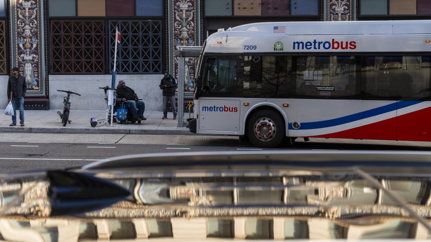 A Metrobus at Metro Center station in Washington, DC, US, on Wednesday, Dec. 20, 2023. Subway riders in Washington are facing a tougher commute next year with the agency that runs the public transit system serving the nation’s capital forecasting thousands of layoffs and service cuts to plug a $750 million budget hole. Photographer: Eric Lee/Bloomberg via Getty Images