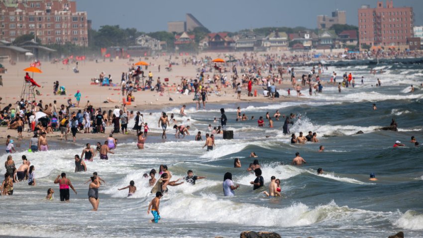 NEW YORK, NEW YORK – JULY 30: People swim in rough surf at Coney Island on July 30, 2024 in New York City. Concerns have been raised about whether there is enough lifeguard enforcement at the city’s public beaches this summer after a total of six recorded drowning incidents have occurred in New York City this summer so far. Lifeguard hours are strictly controlled by the guard union meaning that after 6pm no lifeguards are patrolling city beaches.  (Photo by Spencer Platt/Getty Images)
