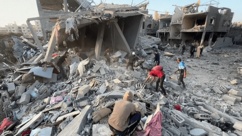 People look through rubble in Gaza strip after Israeli offensive.