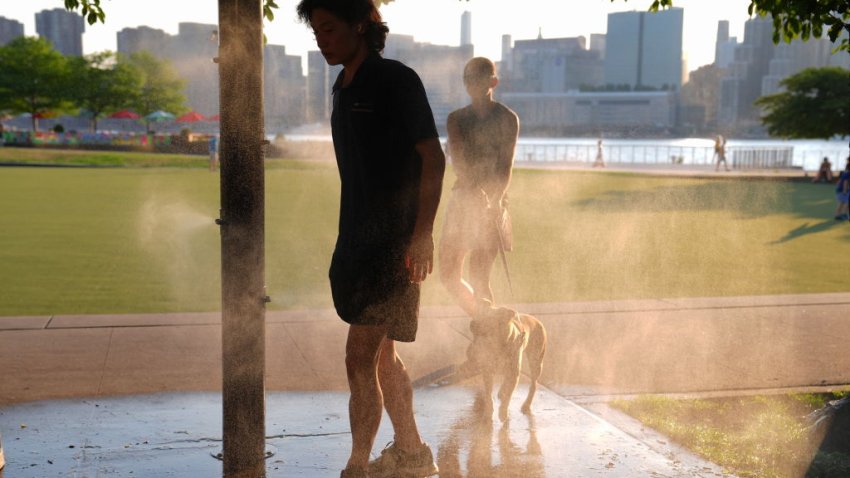 NEW YORK, UNITED STATES – JULY 15: Citizens try to cool off with the sprinklers that helps people cool off during a hot day as the National Weather Service on Monday issued a warning due to hot weather that will remain in effect until Wednesday night in New York City, United States on July 15, 2024. (Photo by Selcuk Acar/Anadolu via Getty Images)