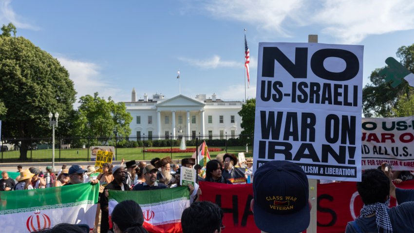 WASHINGTON, DISTICT OF COLUMBIA, UNITED STATES – 2025/06/21: A demonstrator holding a sign that reads “No US-Israel War on Iran” joins a protest in front of the White House. Demonstrators gather outside the Washington Post headquarters and march to the White House to protest Israel’s military operations in Gaza and Iran. (Photo by Probal Rashid/LightRocket via Getty Images)