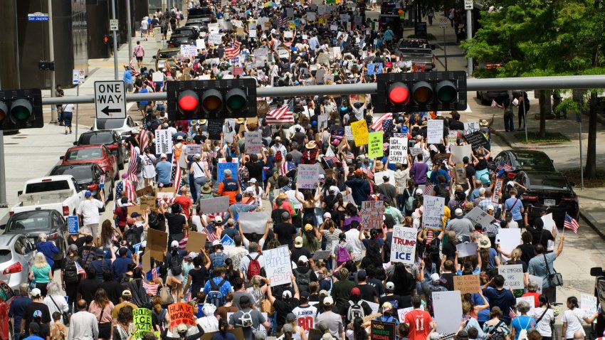Demonstrators march through the streets during the “No Kings” rally in Houston, Texas on June 14, 2025, on the same day as President Trump’s military parade in Washington, DC. In response to the military parade celebrating the 250th anniversary of the US Army but also coinciding with Trump’s 79th birthday, a “No Kings” movement has sprung up promising to stage protests in more than 2,000 places across the country, including a large parade expected in Los Angeles which organizers say will feature a “20-foot-tall balloon of Trump wearing a diaper.” (Photo by Mark Felix / AFP) (Photo by MARK FELIX/AFP via Getty Images)