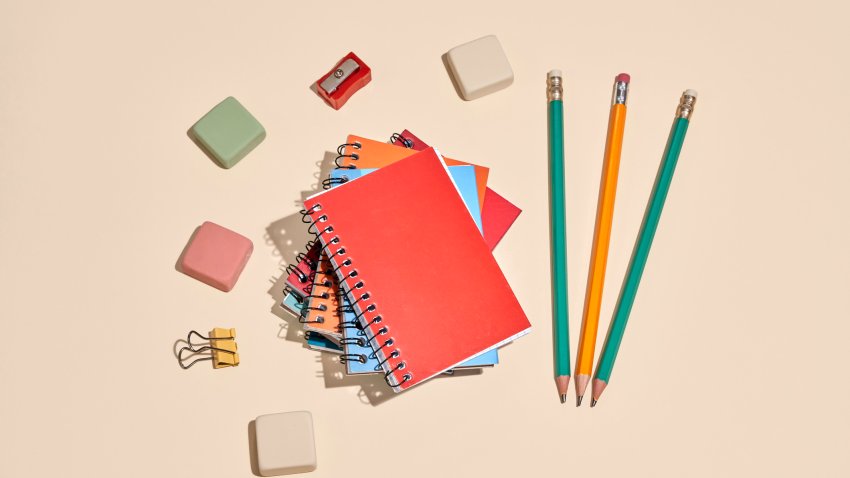 Directly above view of colorful stationery on a pastel background