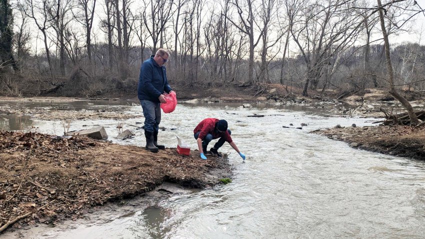 Water samples are taken from the Potomac River, Friday, Jan. 23, 2026 in Glen Echo, Md.  A massive pipe that moves millions of gallons of sewage has ruptured and sent wastewater flowing into the Potomac River northwest of Washington, polluting it ahead of a major winter storm that has repair crews scrambling.  (AP Photo/Nathan Ellgren)