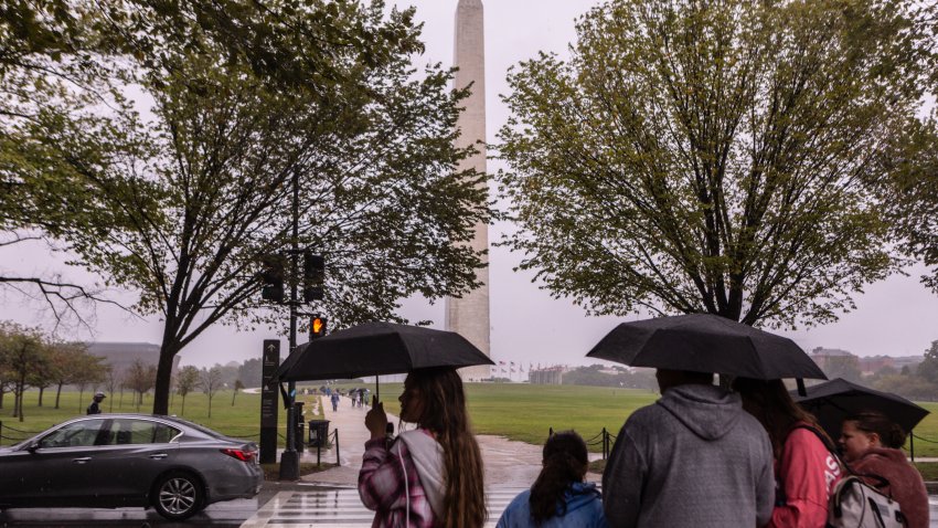 WASHINGTON, DC – SEPTEMBER 23: People walk through the rain on the National Mall on September 23, 2023 in Washington, DC. Tropical Storm Ophelia brought waves of heavy wind and rain to the district, with residents bracing for potential flooding and power outages. (Photo by Anna Rose Layden/Getty Images)