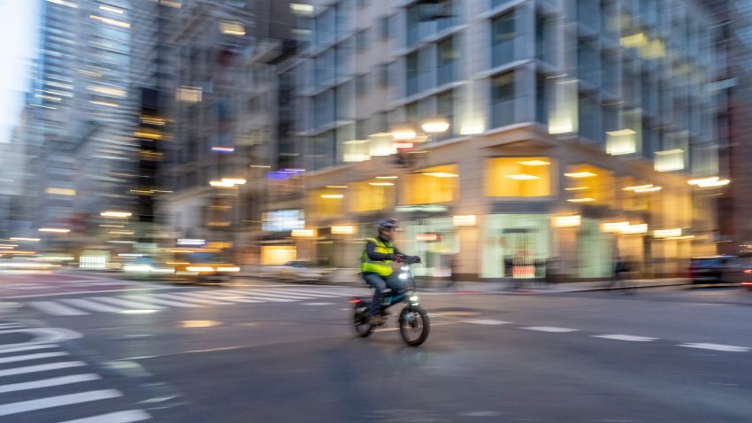 Street photography near Grand Central Station, New York City.  This is on a very wet and dark spring night with wet roads creating reflections of two yellow cabs at a cross roads.  Slow shutter speed creates movement blur for intentional camera movement and give a an abstract background.