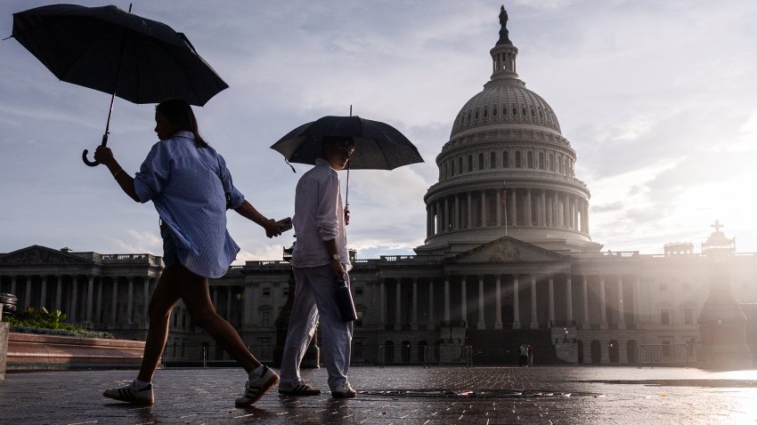 WASHINGTON, DC – JULY 09: People walk with umbrellas outside of the U.S. Capitol Building on July 09, 2026 in Washington, DC. Heavy rain and lightning swept through the city on Thursday night. (Photo by Finn Gomez/Getty Images)