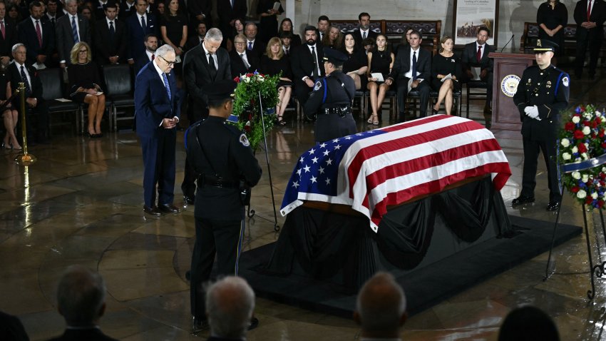 US Senate Minority Leader Chuck Schumer and US Senate Majority Leader John Thune pay their respects at the casket during a Congressional tribute to late US Senator Lindsey Graham at the US Capitol in Washington, DC, on July 28, 2026. Graham, a South Carolina Republican and key Trump ally who was elected to the Senate four times, died at age 71 on July 11. (Photo by Brendan SMIALOWSKI / AFP via Getty Images)