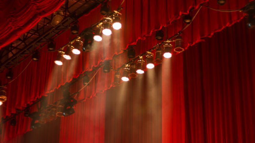 Red curtains and lights on stage at the show.