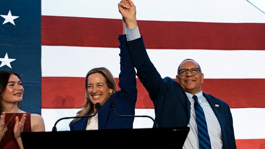 EAST BRUNSWICK, NEW JERSEY – NOVEMBER 04: New Jersey Democratic gubernatorial candidate, Rep. Mikie Sherrill (D-NJ) (C) celebrates with lieutenant gubernatorial candidate Dale Caldwell (R) after their win during an election night watch party at the Hilton East Brunswick Hotel on November 4, 2025 in East Brunswick, New Jersey. Sherrill defeated Republican assembly member Jack Ciattarelli in a tightly contested race for New Jersey governor. (Photo by Eduardo Munoz Alvarez/Getty Images)